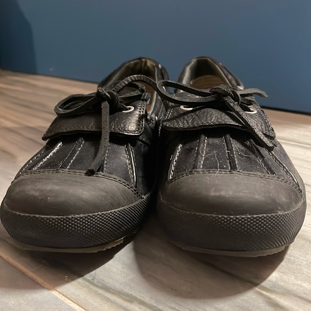 Black Ugg moccasins worn a couple of times. No damage.